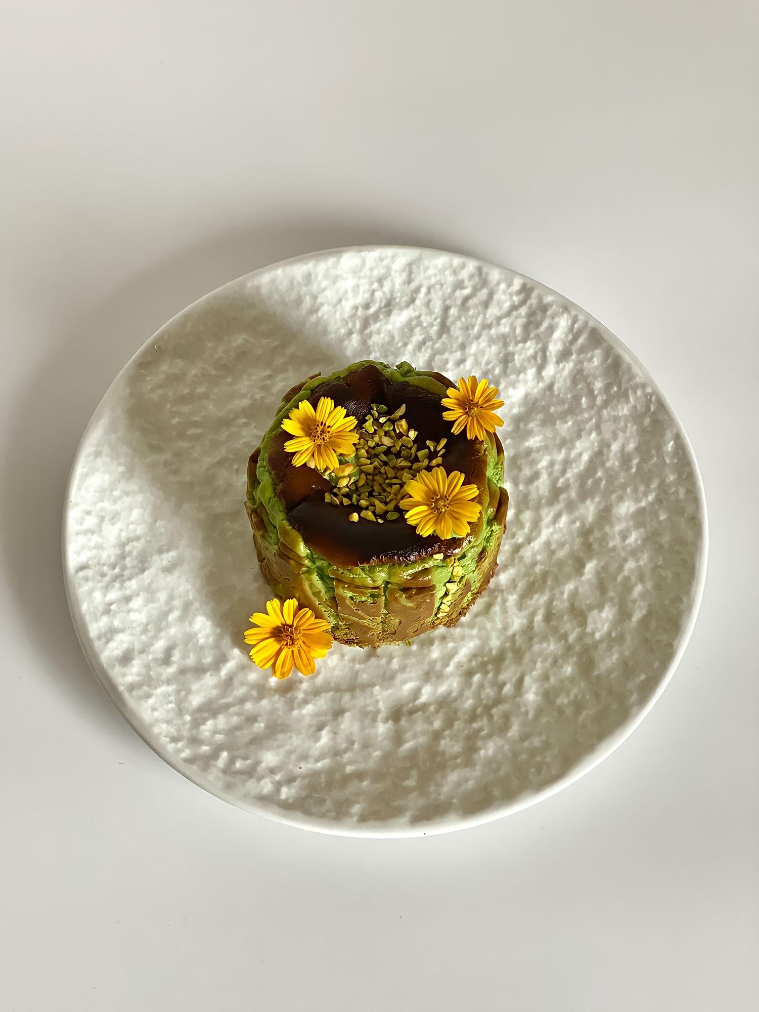 Close-up of plated seasonal dish in soft monochrome setting